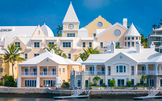 A clocktower rises over the rooftops of a collection of buildings along the Hamilton Bermuda waterfront.