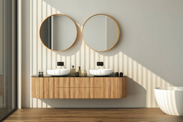 istock Modern bathroom interior with dark brown parquet floor, two sinks, double mirrors, white bathtub, interior plants. Minimalist bathroom with modern furniture and city view. 3D rendering 1469788629