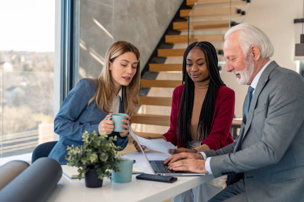 istock Diverse executive managers at meeting in office discussing statistics plan and using laptop 1469788666