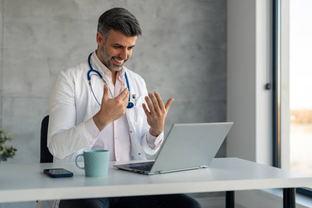 istock Medical professional handsome doctor doing online presentation in office 1469789995