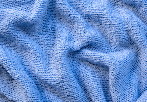 istock knitted wool scarf on white wooden background 1469791212