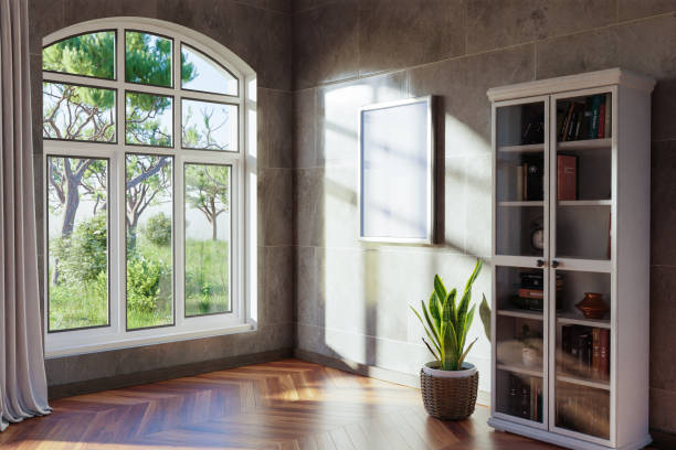 istock empty canvas poster mock up hanging on a wall; empty living room interior; bright daylight shining through a large window; home decoration desing; 3D Illustration 1469794019