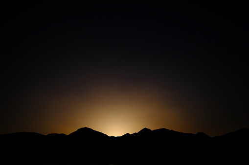 Mountains and scenery in silhouette during sunset time