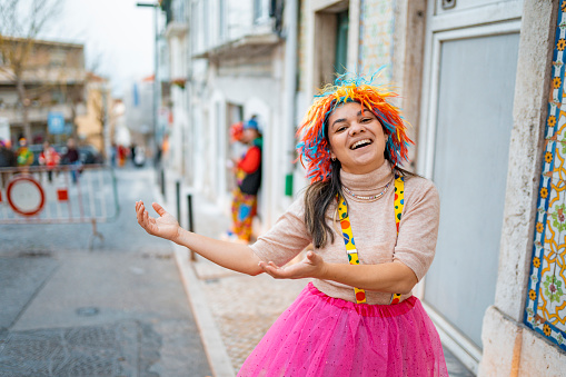 Woman wearing clown costume having fun at street carnival