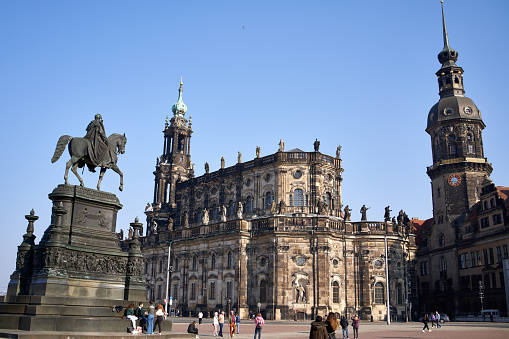 Dresden, Germany - March 24, 2022: Monument to King Johann, Hausmannsturm and Holy Trinity Church at Theaterplatz square