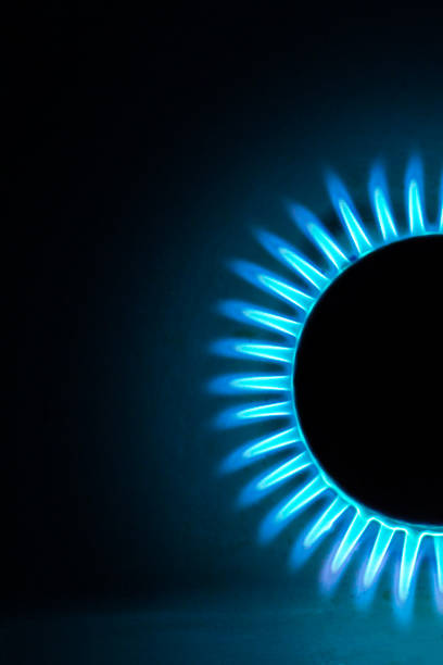 istock a hundred dollar bill on a gas burner with a burning fire on a black background, the front and back background is blurred with a bokeh effect 1469805530