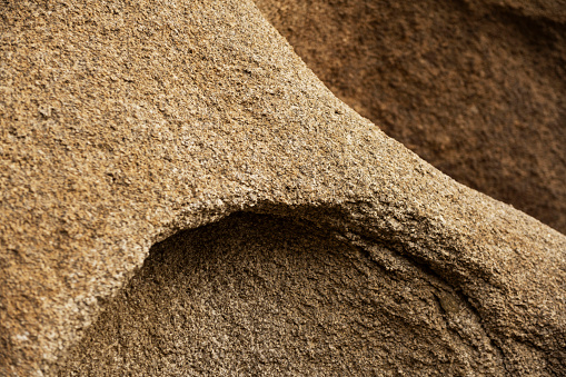 This is a close up photograph of a large rock formation texture Joshua Tree national park, California.
