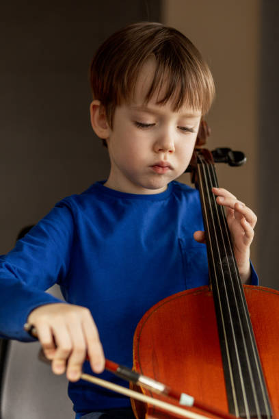 istock White 5 year old boy learning to play the cello 1469806705