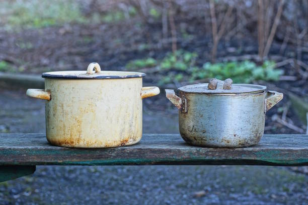 istock two old metal dirty pans stand on a table 1469809936