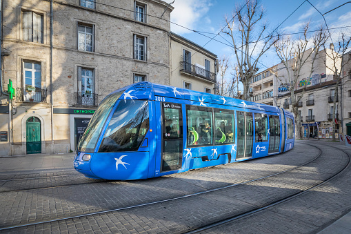 Montpellier, France - January 16 2018: Blue modern tram on the street of the city