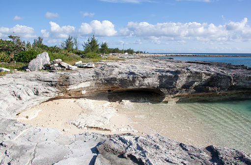 The scenic view of a small beach surrounded by eroded coastline on Grand Bahama island.