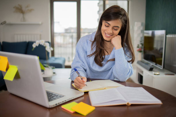 istock Happy young woman is learning online 1469812175