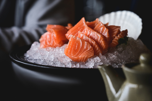 Japanese food concept. salmon sashimi on a bowl with ice.