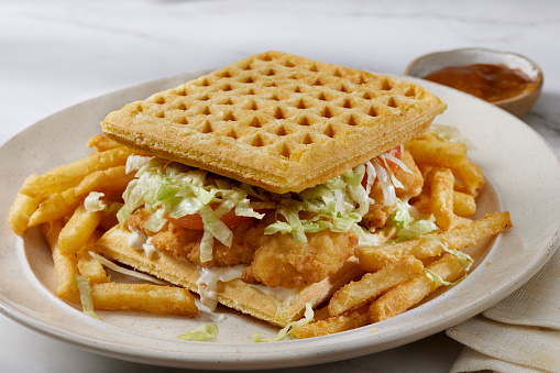 Fried Chicken Tender Waffle Sandwich with Lettuce, Tomato, Mayo, Fries and Gravy