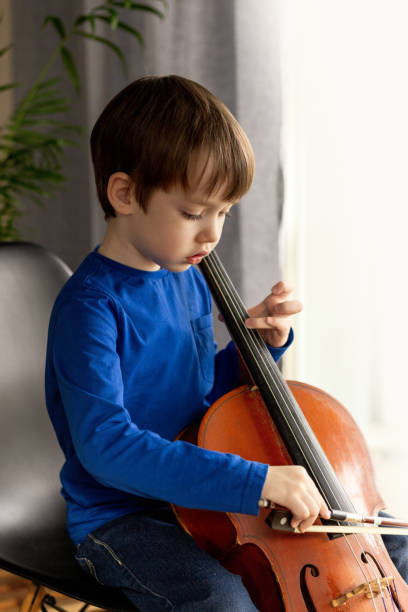 istock White 5 year old boy learning to play the cello 1469813142