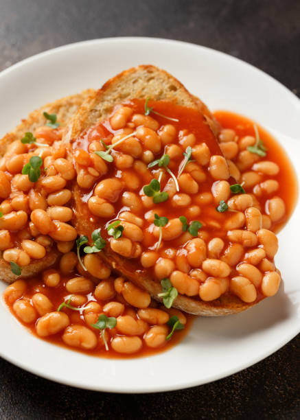 istock Baked beans on toast in tomato sauce on white plate 1469813281