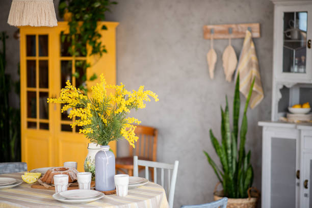 spring, easter interior in scandinavian style. rustic living room with bright wardrobe yellow mimosa - vehicle interior green sofa indoors imagens e fotografias de stock