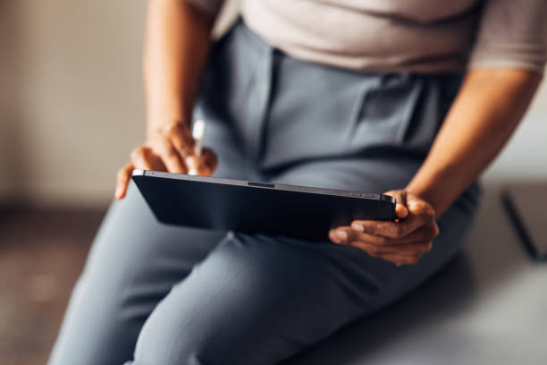 istock An Unrecognizable Businesswoman Working On Her Tablet 1469817298