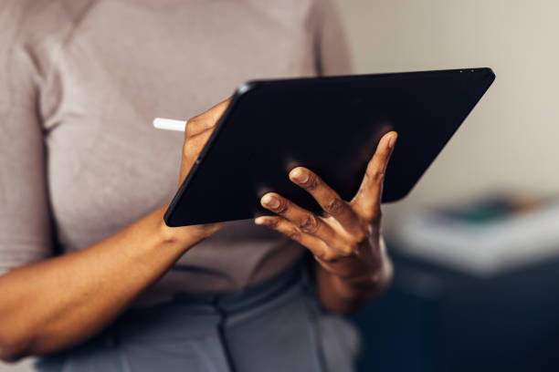 istock An Unrecognizable Businesswoman Holding A Pen While Working On Her Tablet 1469817342