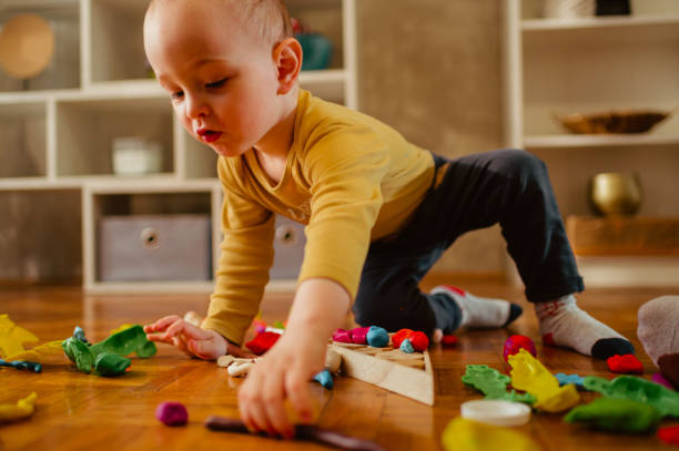 istock Toddler child playing with modeling clay in a kindergarten or home 1469828635