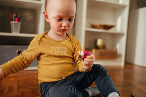 istock Toddler child playing with modeling clay in a kindergarten or home 1469828640