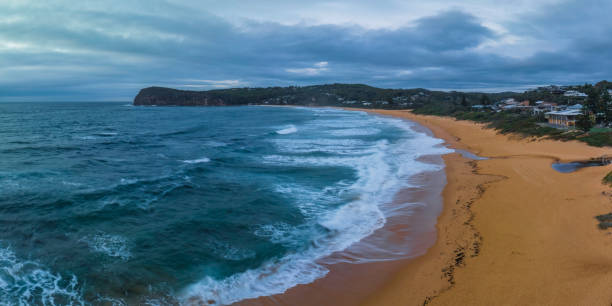 istock Cloudy sunrise panorama at the beach 1469828814