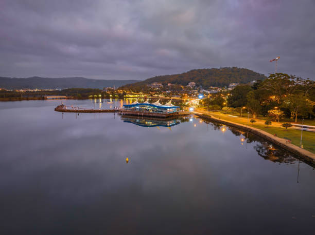 istock Cloudy sunrise waterscape over Gosford Waterfront and Drifters Wharf with reflections 1469828996