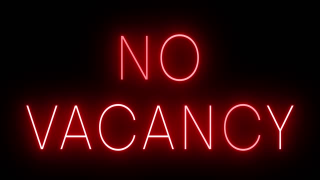 Glowing and blinking red retro neon sign for NO VACANCY
