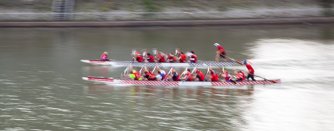 picture with camera made motion blur effect of two canoes having a race on a canal