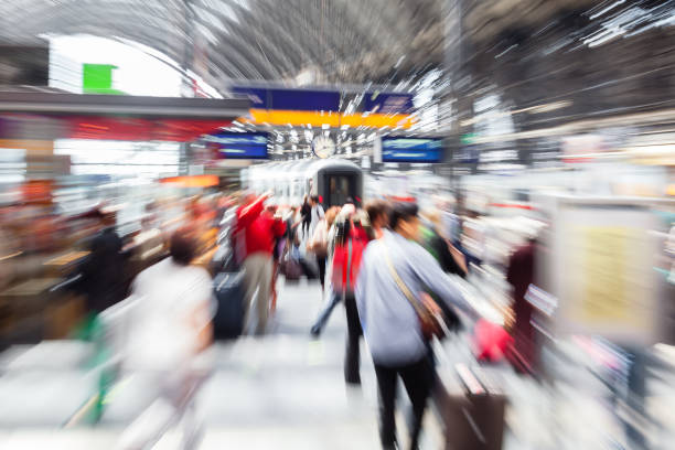 abstract picture with camera made zoom effect of crowds of people at a train station