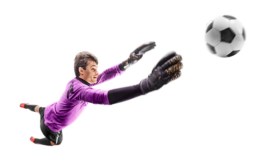 Goalkeeper in action. Goalkeeper catching ball in jump. The concept of sport. Silhouette of sportsmen with ball isolated on white background. Sport