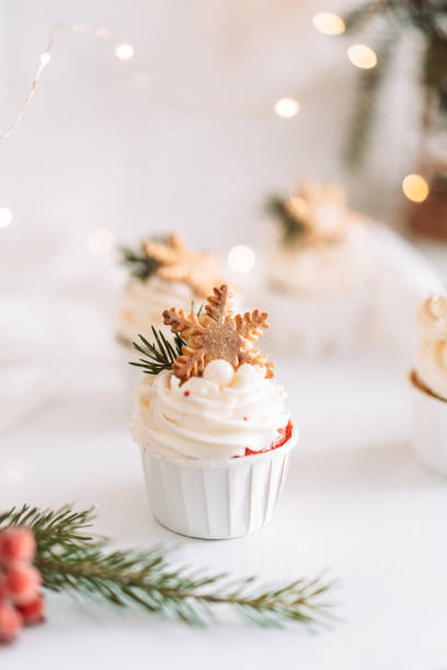 istock Muffins with snowflake cookies in front of Christmas decorations 1469841321