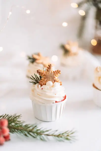 Photo of Muffins with snowflake cookies in front of Christmas decorations