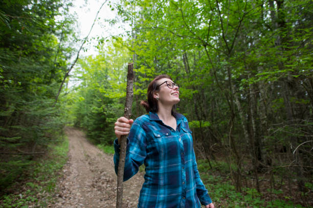 istock Woman Walking in the Forest on a Trail 1469841425