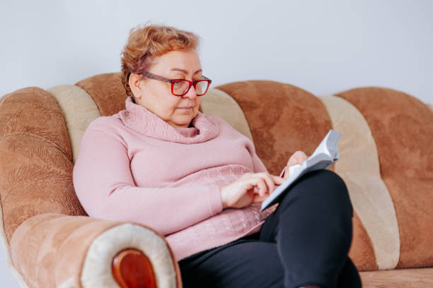 istock Focusing on Knowledge Overweight Woman Reading with Eyeglasses 1469845103