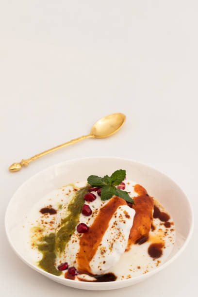 istock Dahi Bhalla Also Called Dahi Vada, Dahi Bhalle Or Dahi Bada Are Fried Lentil Dumplings Made Of Soaked Split Urad Dal And Moong Daal Topped With Whip Curd, Masala Powder, Meethi, Hari Pudina Chutney 1469846073