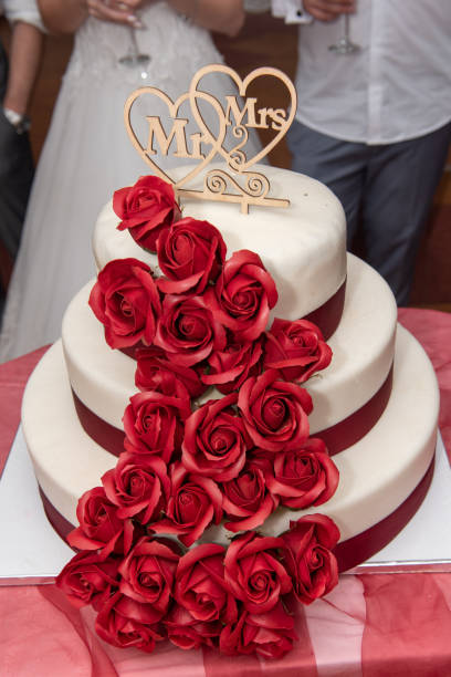 istock Wedding cake decorated with red  roses 1469849717