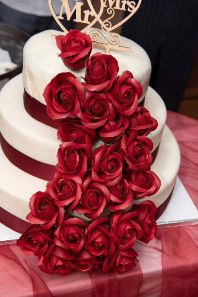 istock Wedding cake decorated with red  roses 1469850075