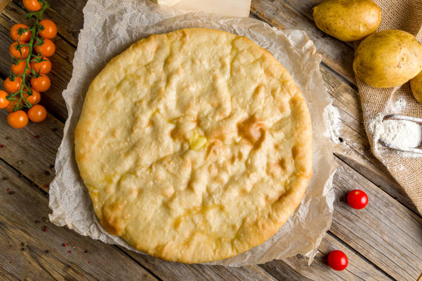 istock Ossetian pie with cheese and potatoes on wooden table top view 1469854225