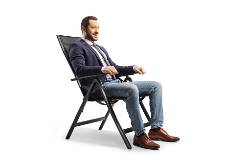 Young man resting in a foldable chair isolated on white background