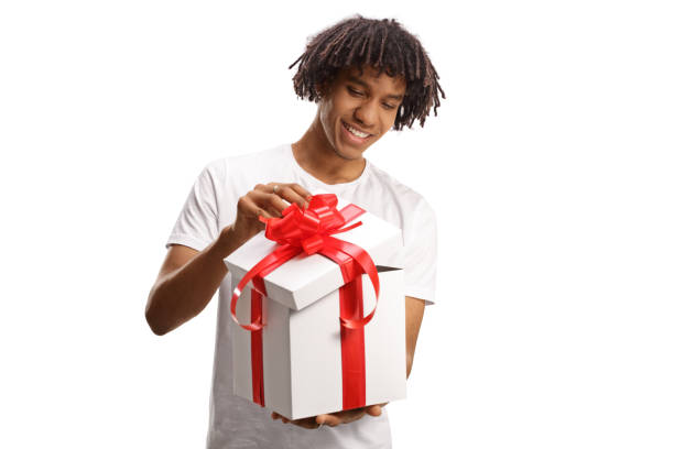 istock Happy young african american guy opening a gift box with red ribbon 1469856131