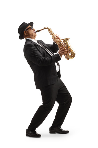 Full length profile shot of a mature elegant musician playing a sax isolated on white background