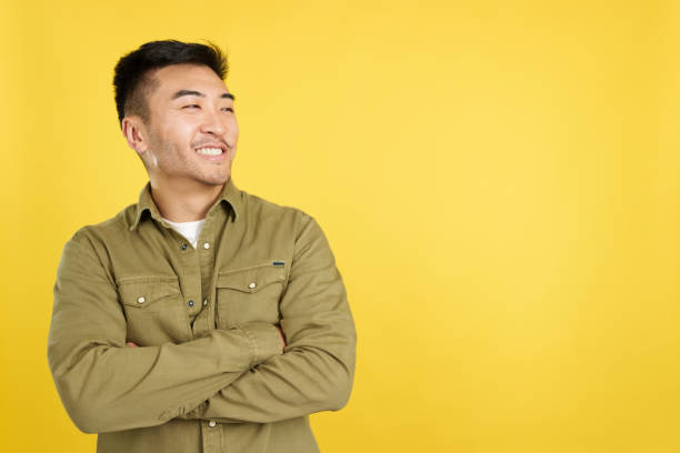 istock Chinese man smiling while looking to the side 1469858987