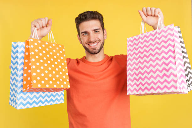 istock Caucasian man raising many shopping bags while smiling 1469859034