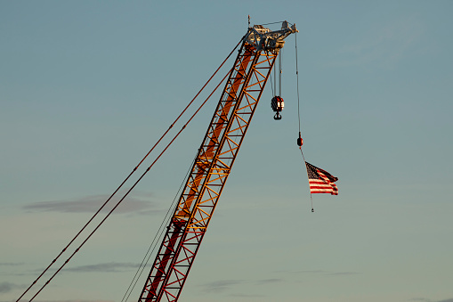 Construction crane with American flag hanging