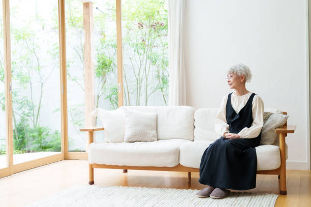 istock senior asian woman sitting on the sofa 1469859872