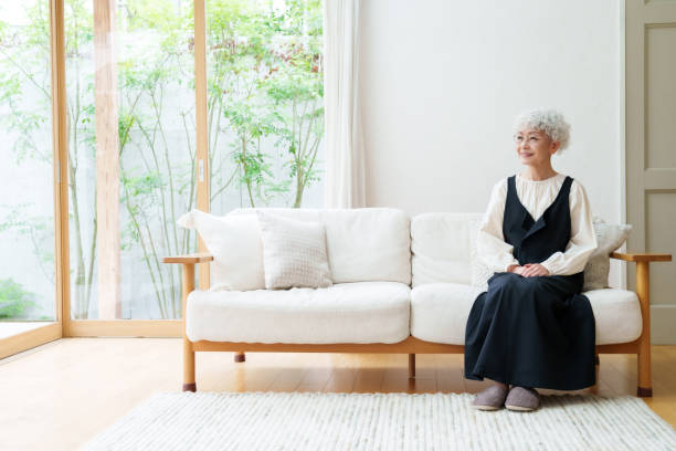 istock senior asian woman sitting on the sofa 1469859873