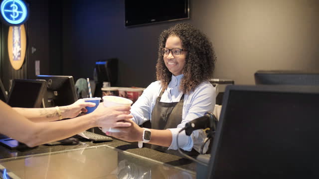 Cinema waitress serving customers