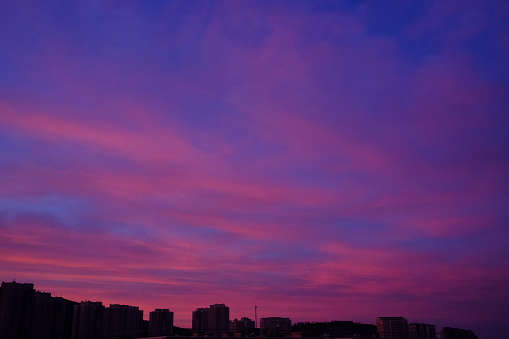 City in silhouette with a dramatic colorfull sky right before sun rises