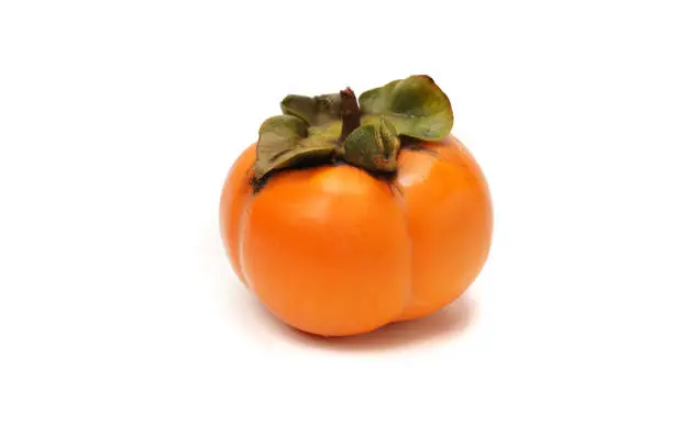 Photo of orange fresh persimmon on the white background